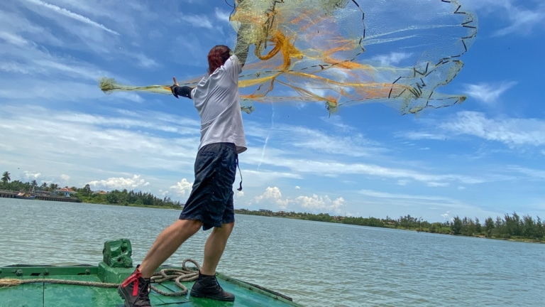 local-fisherman-casting-net-cam-thanh-village